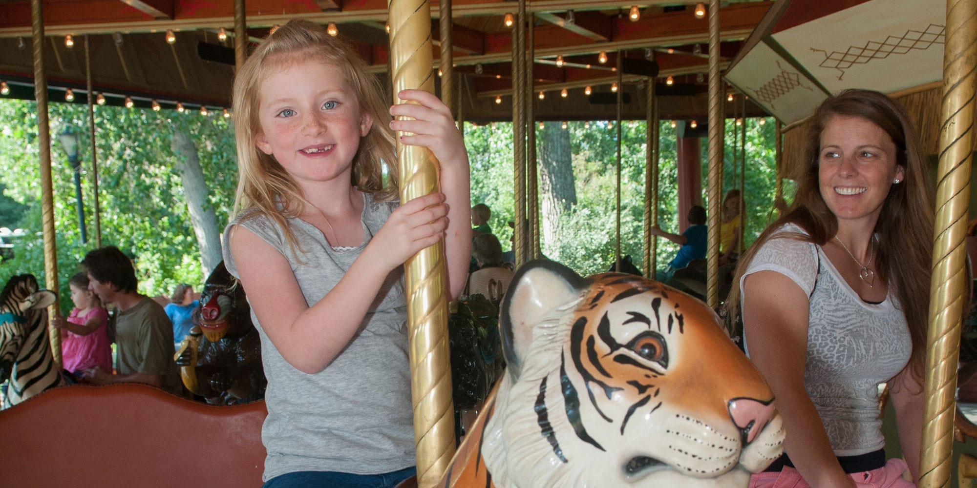 Girl riding on Denver Zoo Carousel