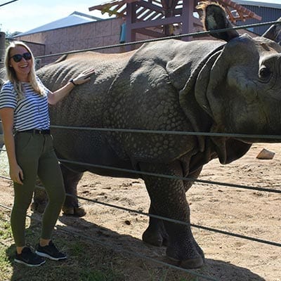 Woman petting rhino