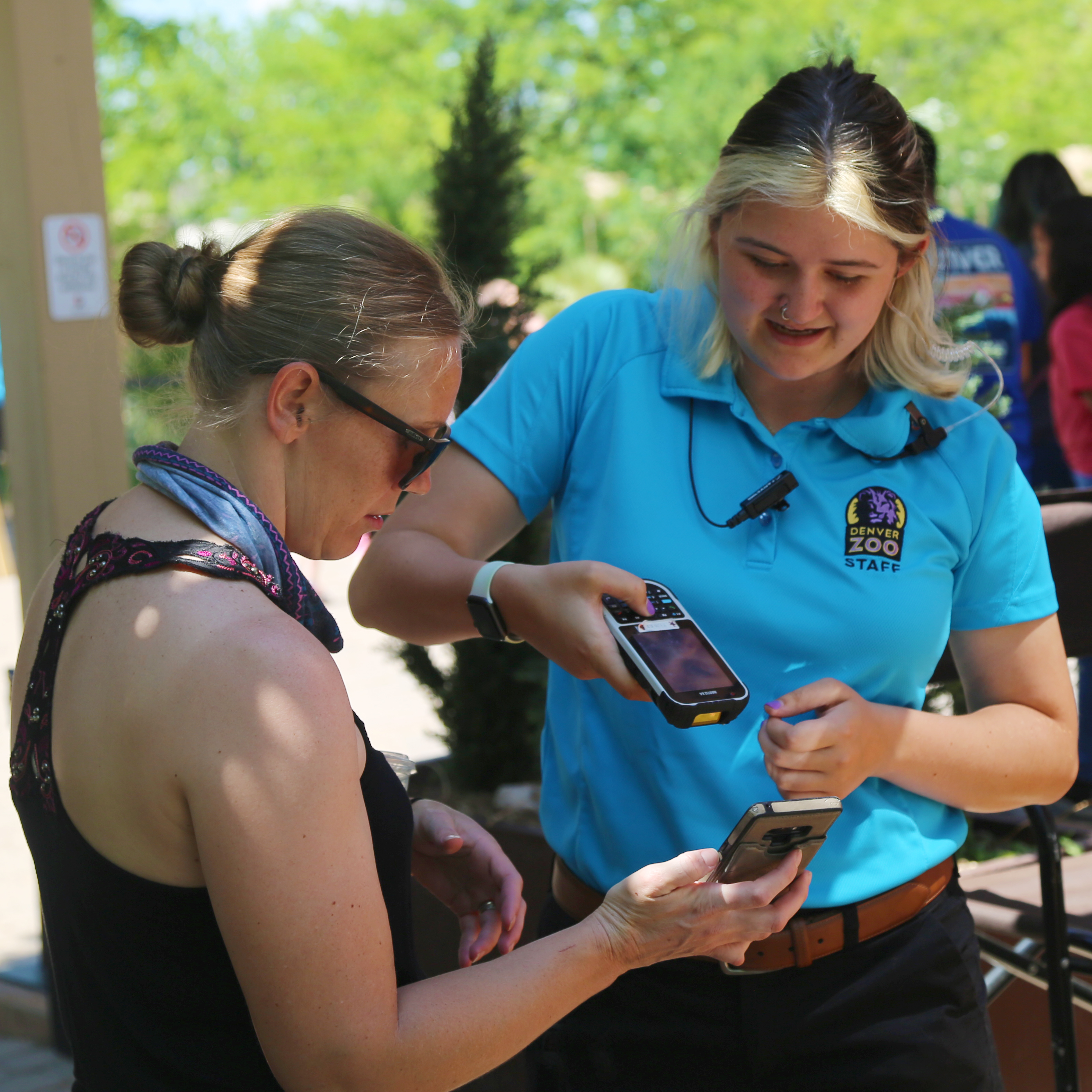 Denver Zoo employee scanning mobile ticket for guest admission. Thumbnail.